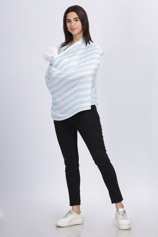 Full-length view of mother feeding baby under the striped nursing cover